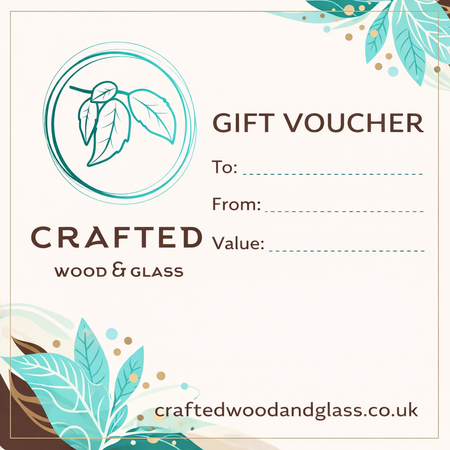A square gift voucher design for Crafted Wood & Glass, featuring a teal circular leaf logo, the text 'GIFT VOUCHER', 'To:', 'From:', and 'Value:', with 'craftedwoodandglass.co.