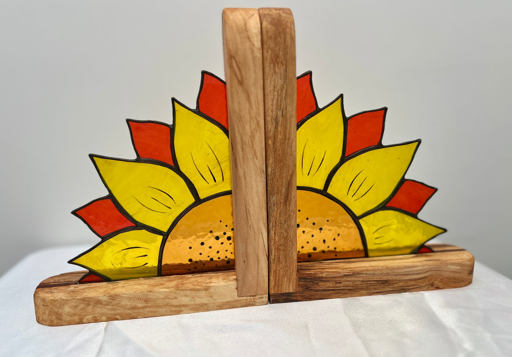 A pair of wooden bookends featuring a hand-painted sunflower design with yellow petals, orange-red outer rays, and a natural wood finish.