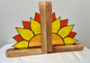 A pair of wooden bookends featuring a hand-painted sunflower design with yellow petals, orange-red outer rays, and a natural wood finish.