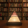 tiffany style pyramid lamp with a bookshelf behind