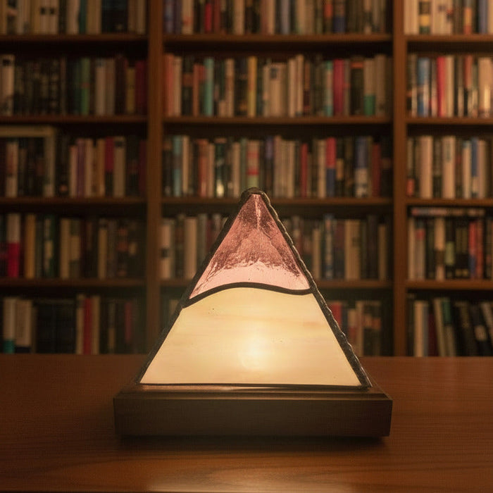 tiffany style pyramid lamp with a bookshelf behind