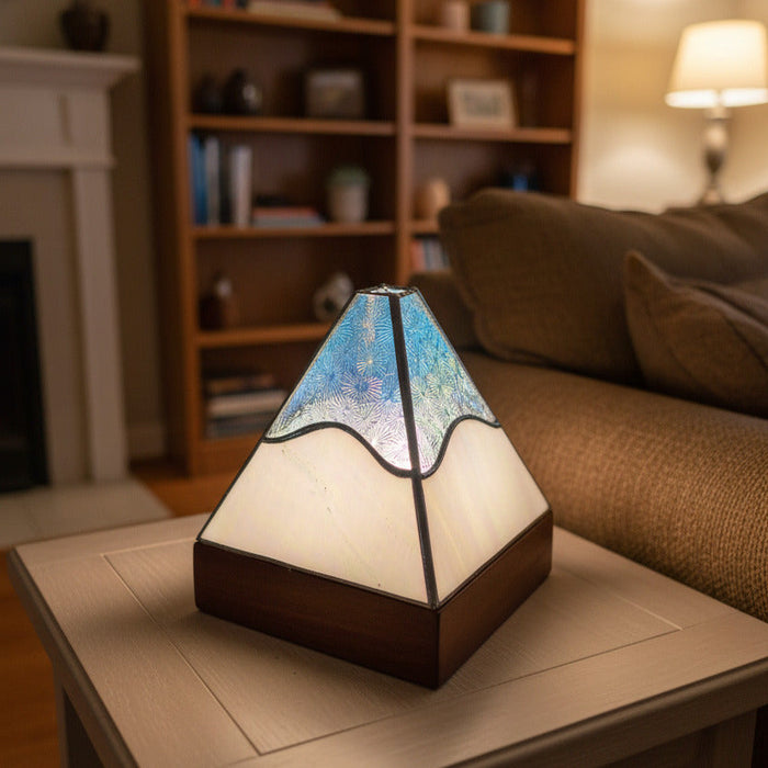 Tiffany style geometric pyramid lamp on a coffee table in a living room 